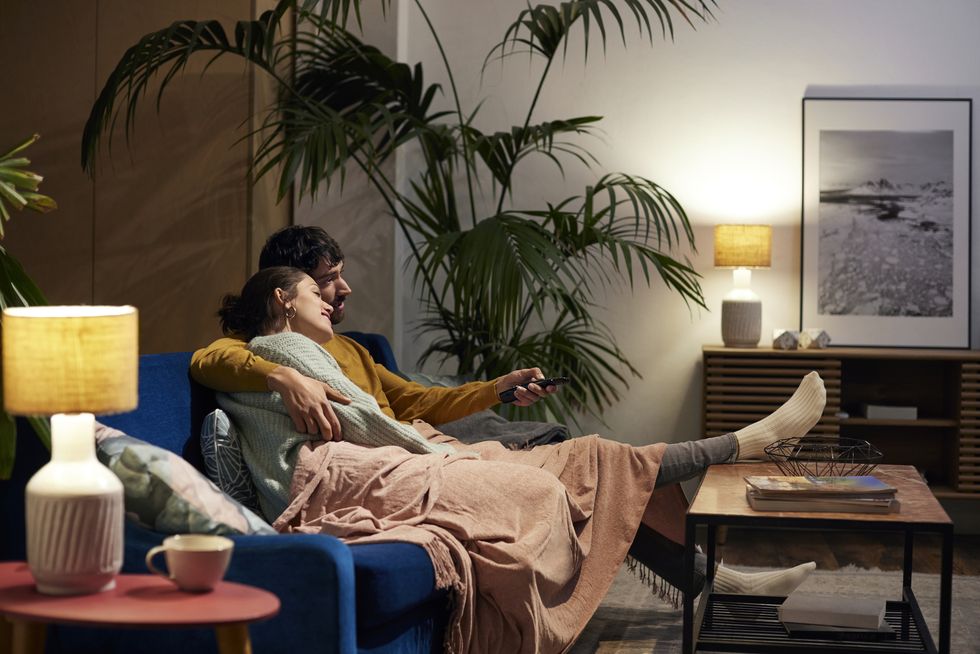 mid adult couple watching tv in living room