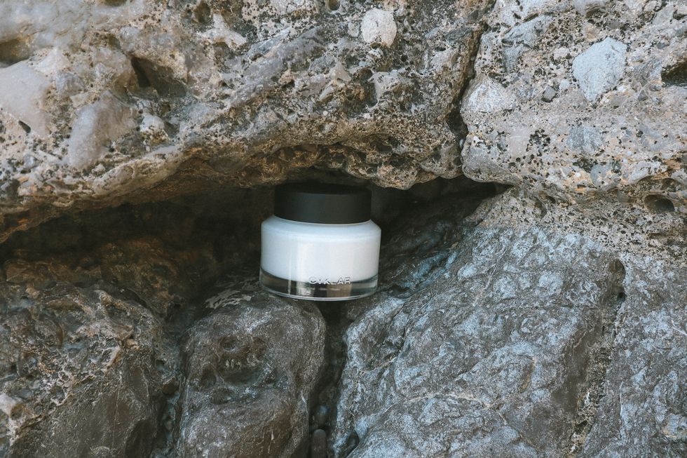 the body cream sitting on a rock