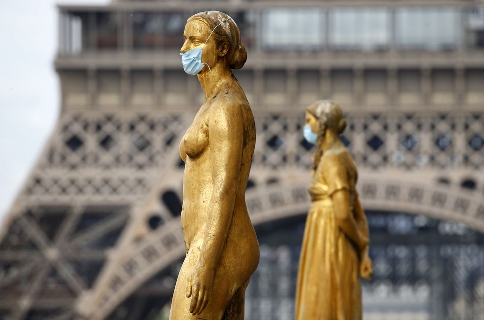 paris, france may 03 golden statues at the trocadero square near the eiffel  tower wear protective face masks as the lockdown continues due to the coronavirus covid 19 pandemic, may 3, 2020 in paris, france the coronavirus covid 19 pandemic has spread to many countries across the world, claiming over 244,000 lives and infecting over 34 million people photo by chesnotgetty images