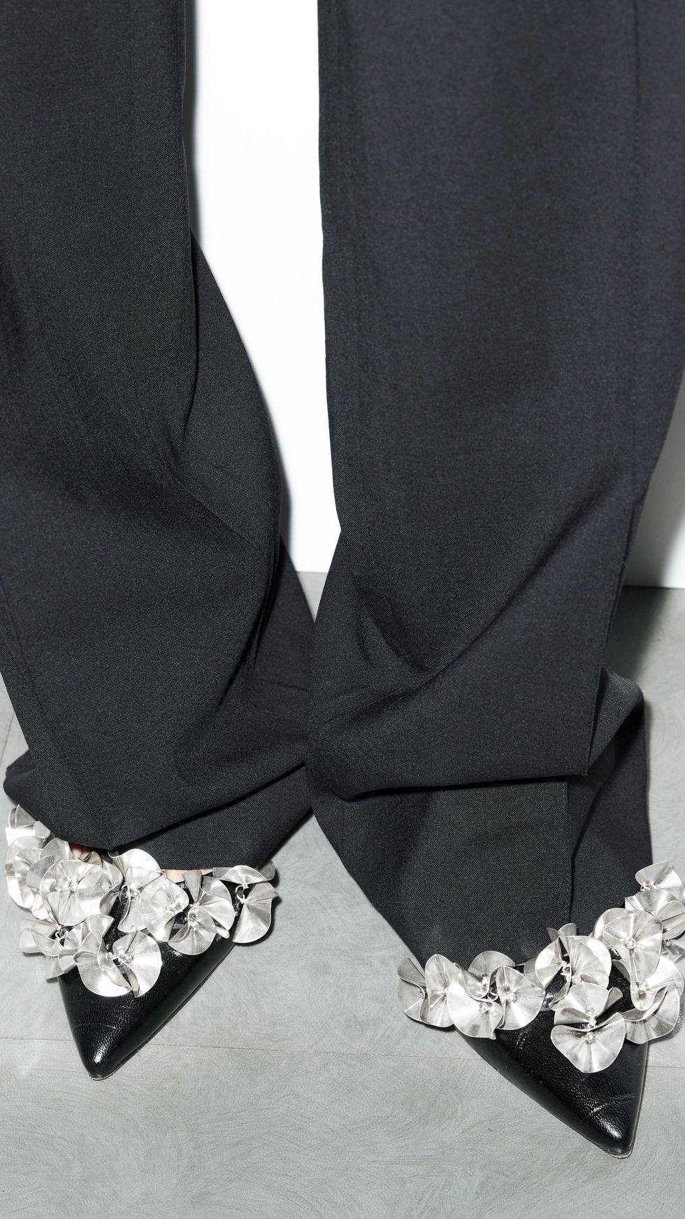 a black suit with a white flower on the lapel