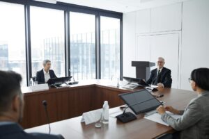 Professional business meeting in modern conference room with executives discussing strategy