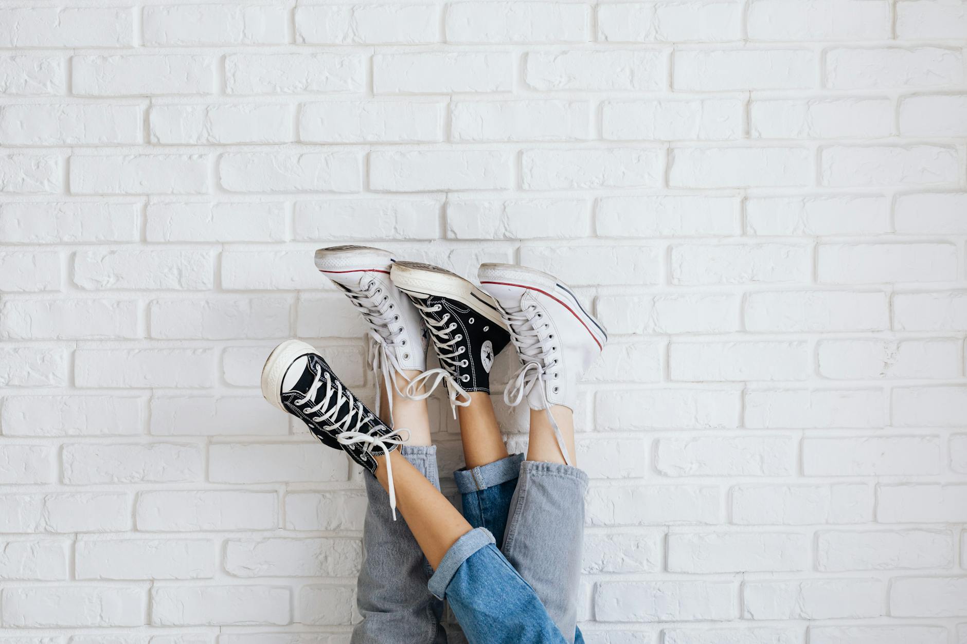 Clean white orthopedic sneakers on neutral background showing modern design and comfort features