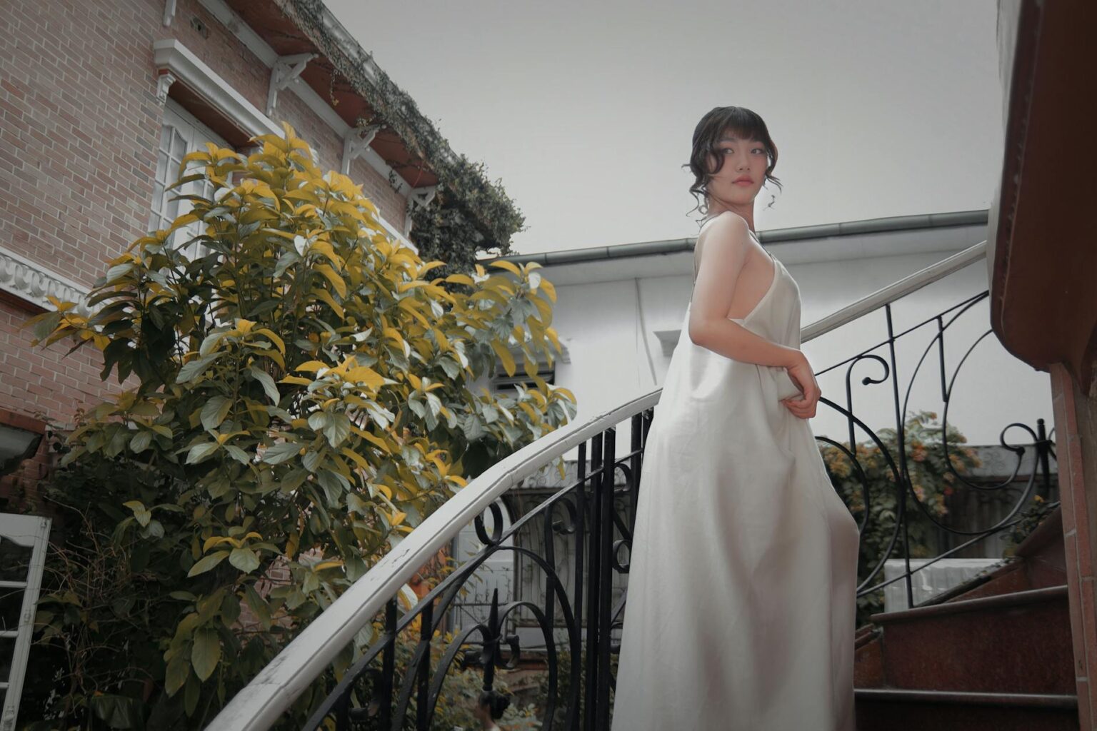 Vintage white wedding dress hanging in closet showing classic elegant style