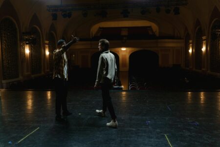 How Facial Cupping Replaced Dermal Fillers Among Broadway Performers Bright stage lights illuminating a theater interior with dramatic lighting