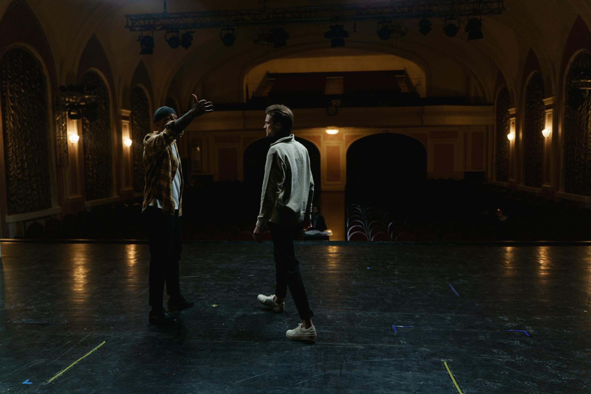 Bright stage lights illuminating a theater interior with dramatic lighting