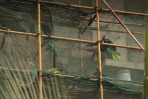 Why Designers Are Staging Collections Inside Active Construction Sites Construction site with scaffolding and building materials creating an industrial backdrop