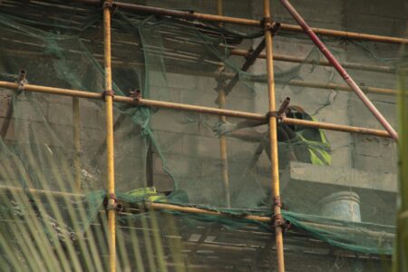 Construction site with scaffolding and building materials creating an industrial backdrop