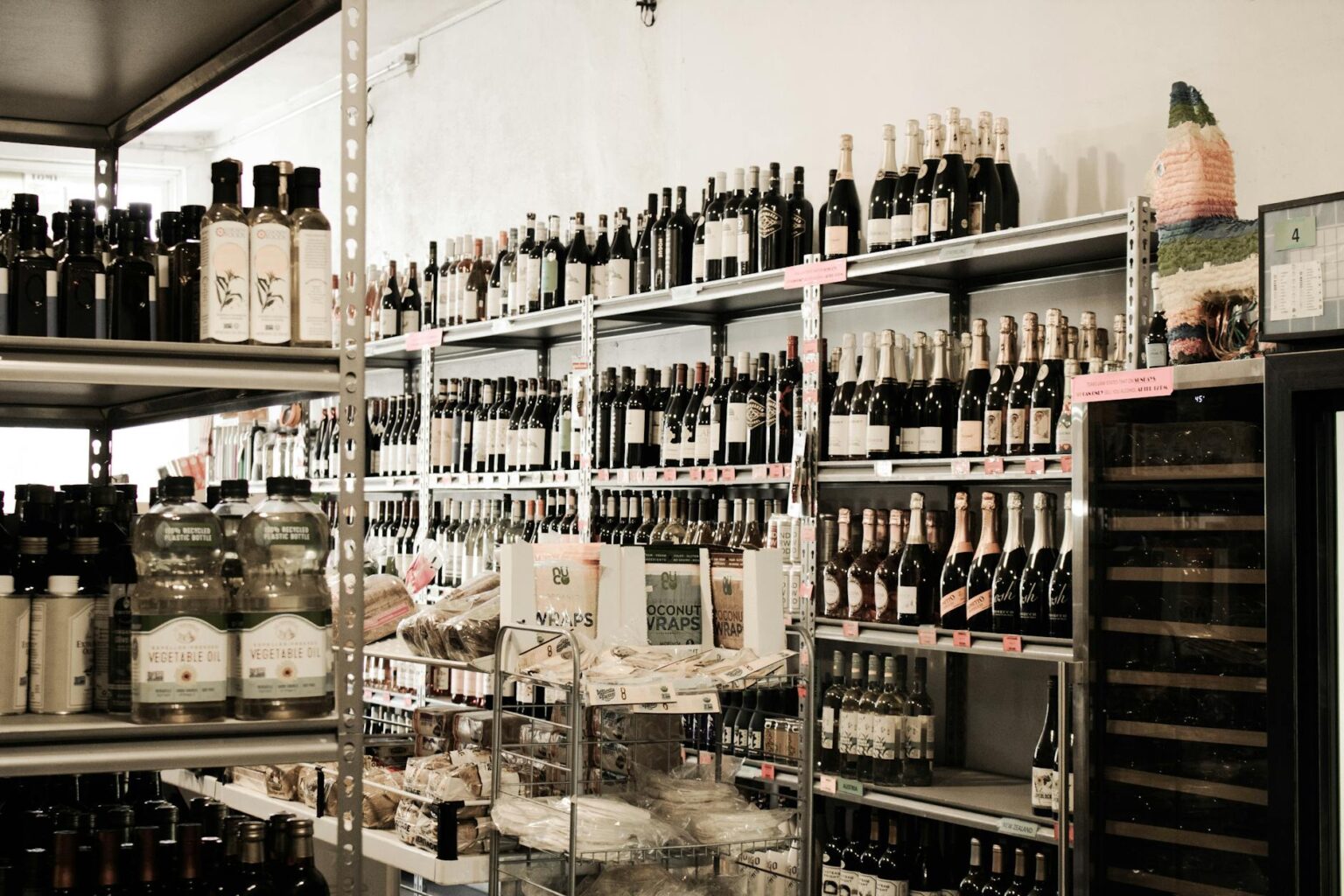 Interior view of grocery store aisle with shelves and fluorescent lighting