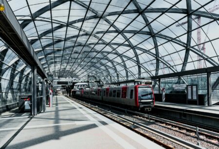 Modern train station interior with platforms and architectural details