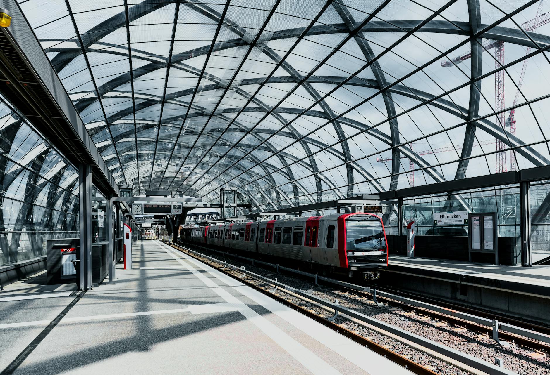 Modern train station interior with platforms and architectural details