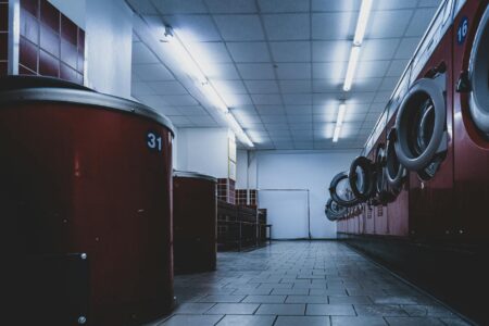 Why Designers Are Staging Collections Inside Active Laundromats Interior view of a modern laundromat with washing machines and bright lighting