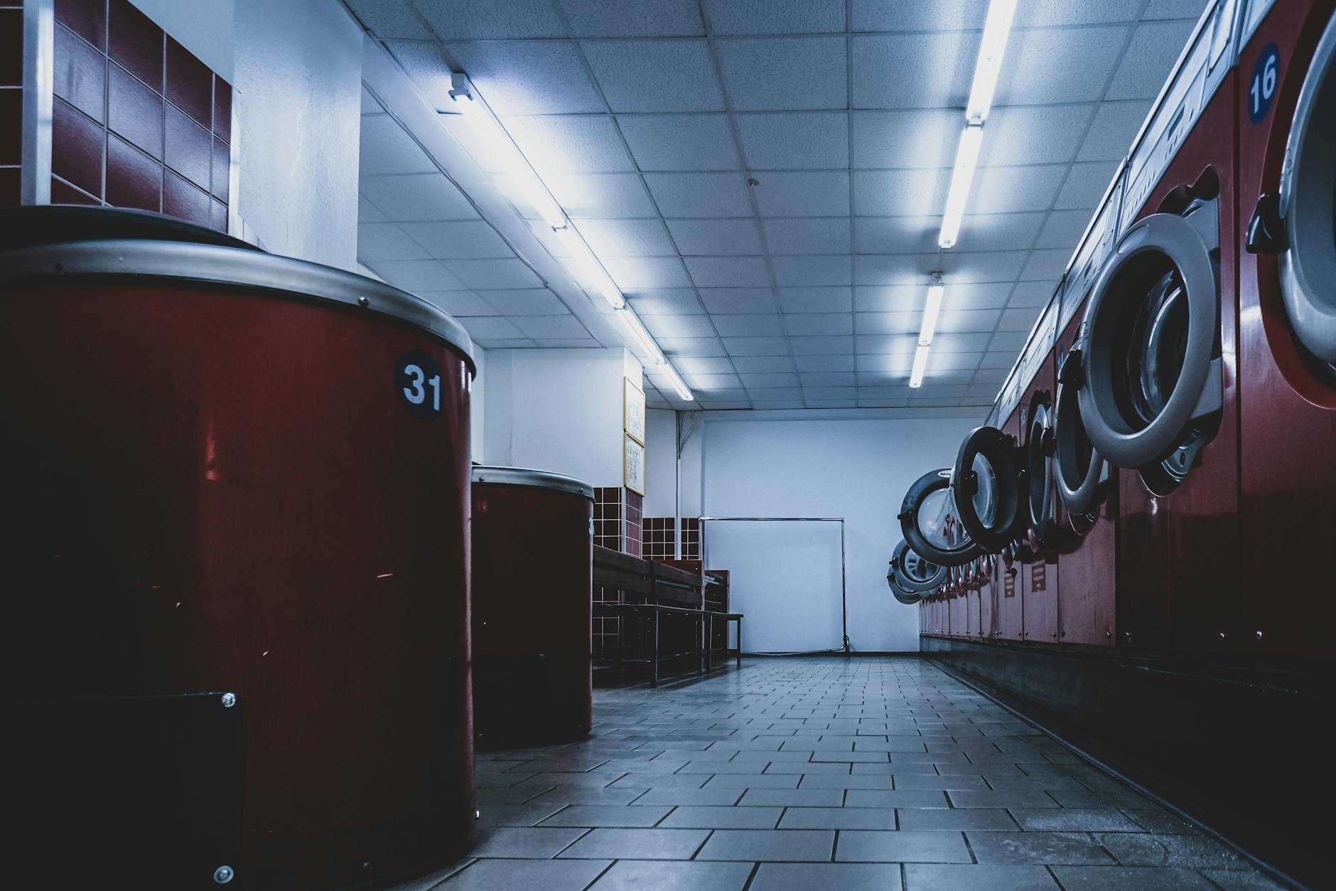 Interior view of a modern laundromat with washing machines and bright lighting