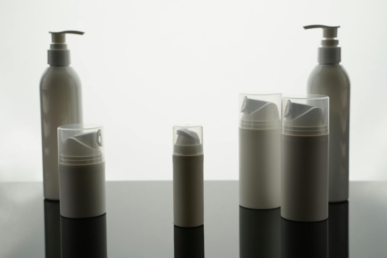 Multiple skincare products arranged on clean surface showing layering routine essentials
