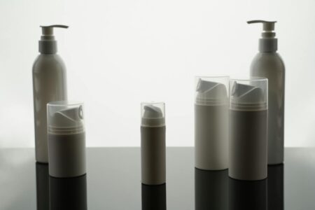 Multiple skincare products arranged on clean surface showing layering routine essentials