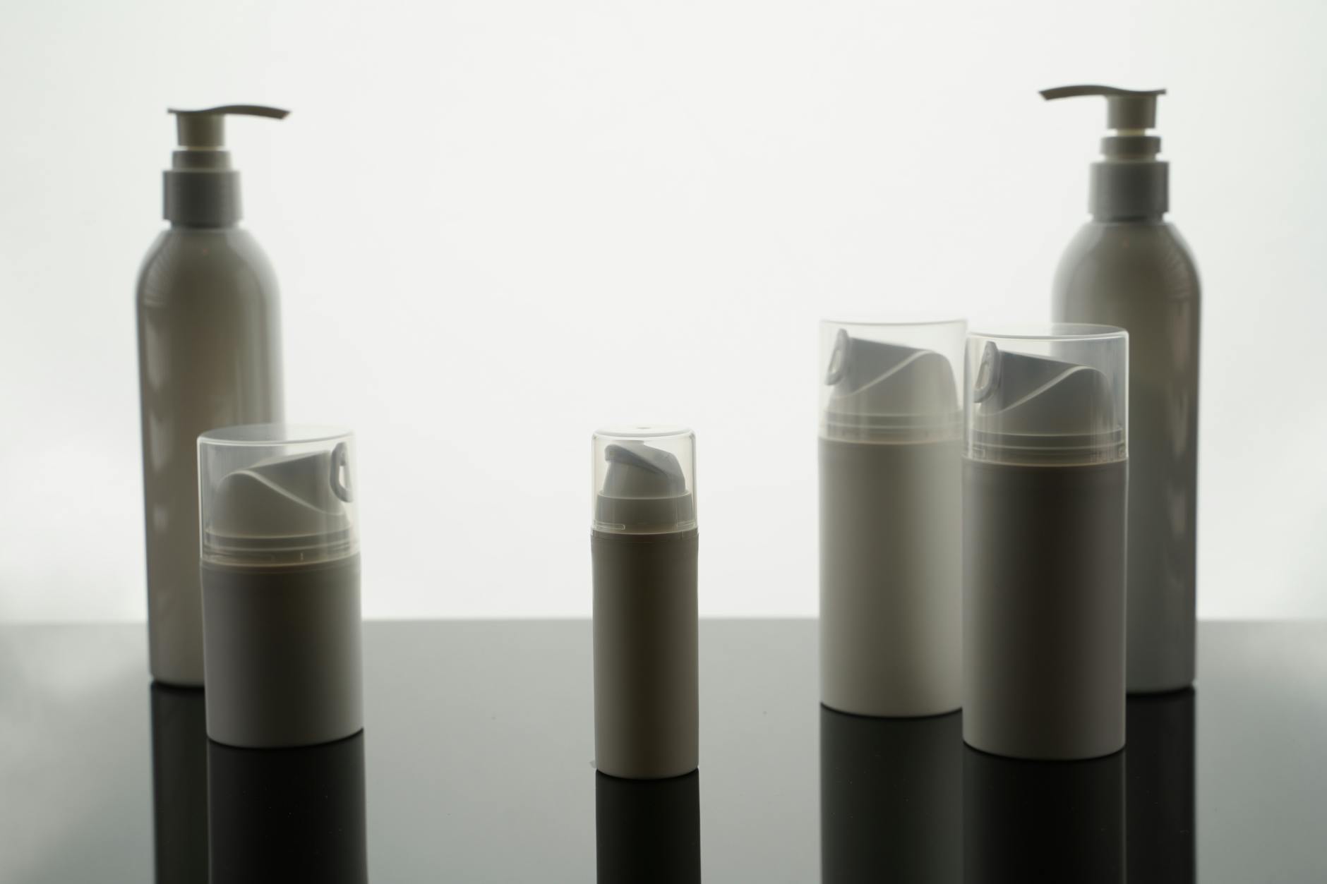Multiple skincare products arranged on clean surface showing layering routine essentials