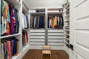 Well-organized professional closet with neatly arranged suits, shirts, and accessories