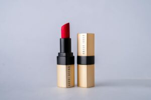 Close-up of brown lipstick being applied to lips showing rich, chocolate-toned color