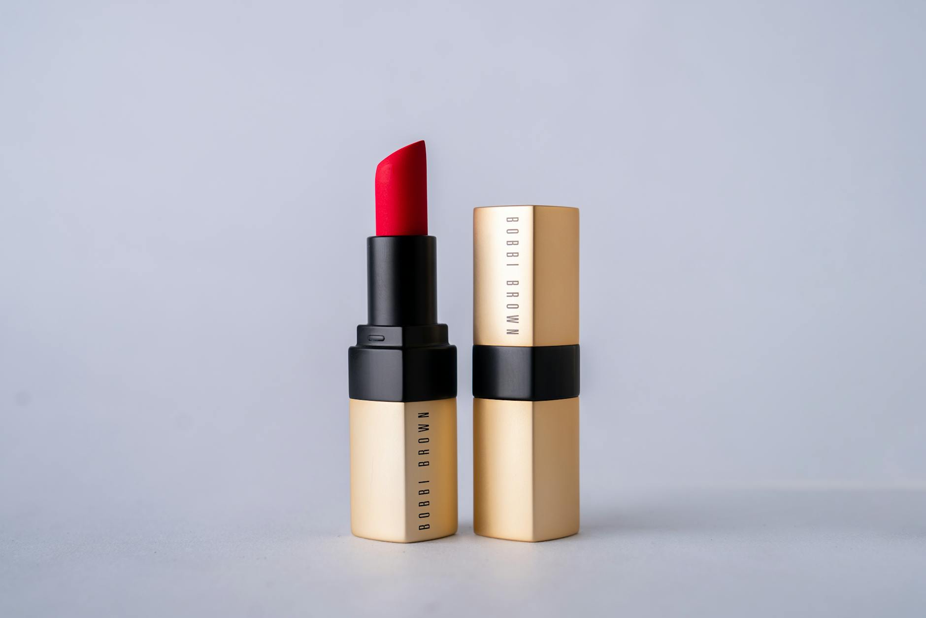 Close-up of brown lipstick being applied to lips showing rich, chocolate-toned color