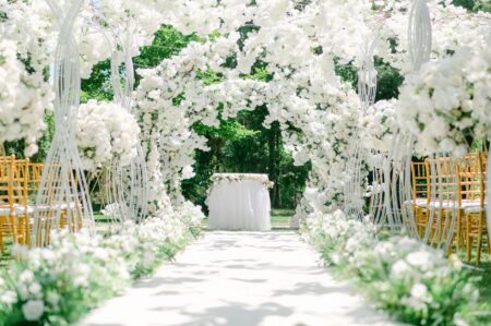 Elegant white wedding dress hanging in vintage boutique setting