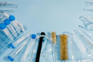 Clean medical laboratory with testing equipment and sample vials on white countertop