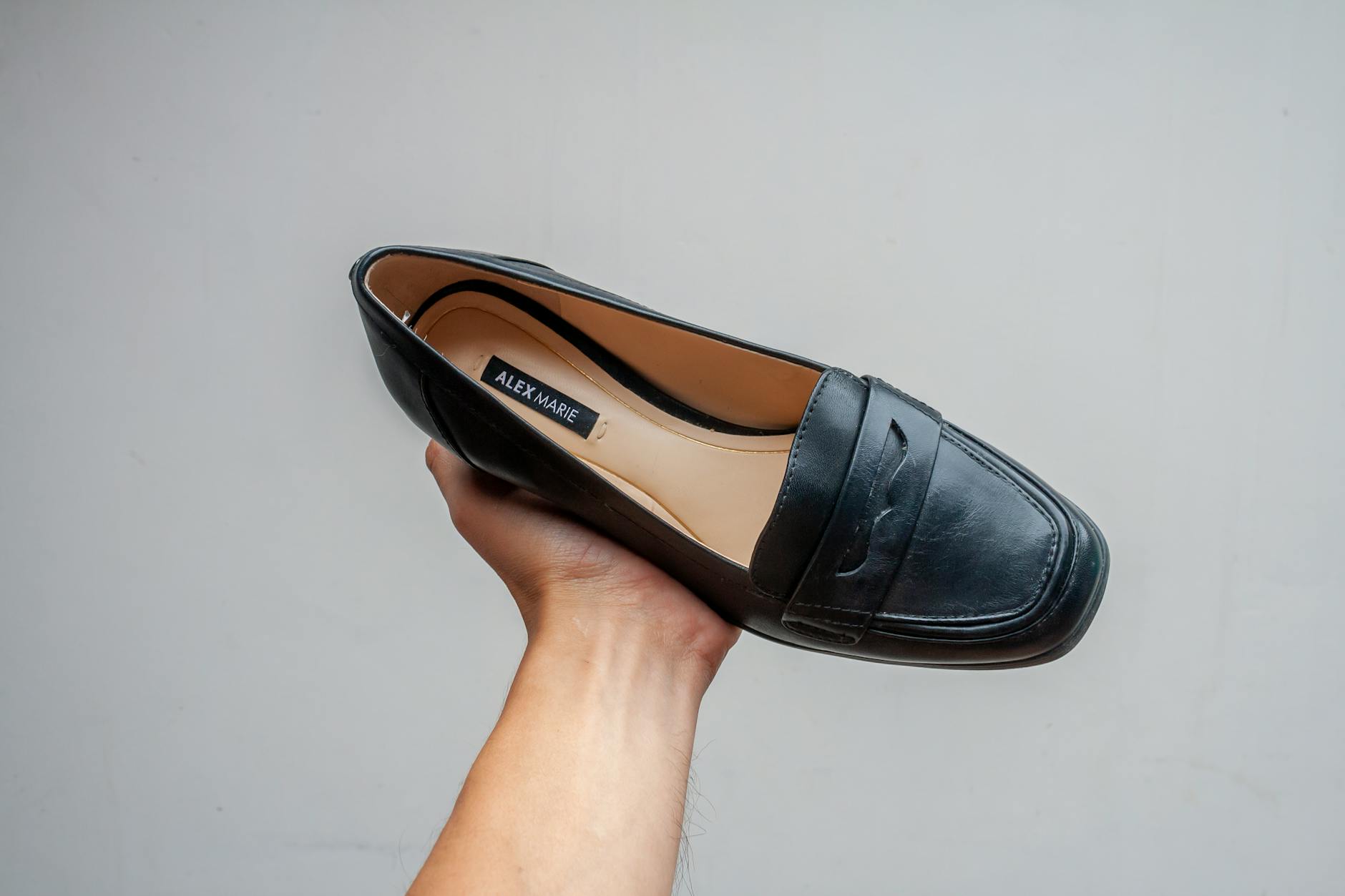 Classic black Mary Jane shoes with ankle straps displayed on white background