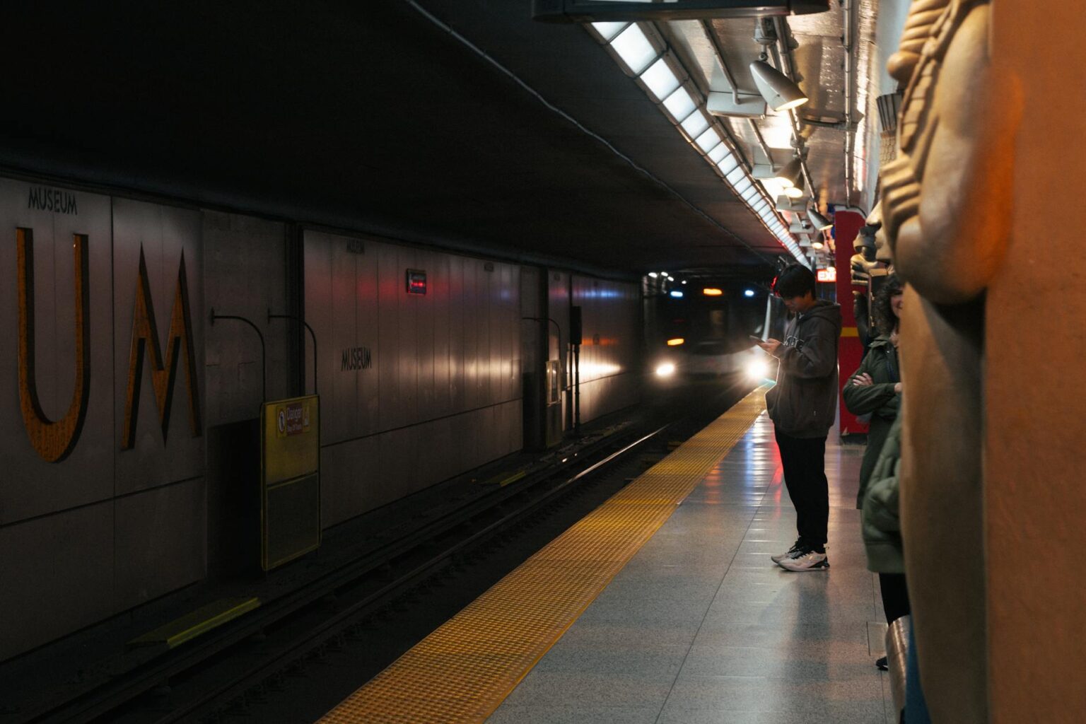 Modern subway platform with fluorescent lighting and tiled walls showcasing urban transit infrastructure