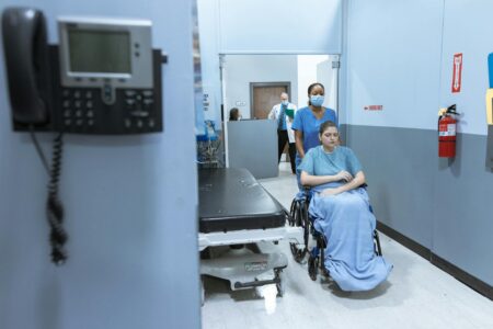 Modern hospital corridor with medical equipment and clean white walls