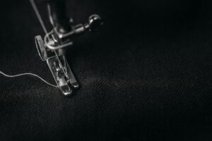 Why Luxury Brands Are Collaborating with Prison Textile Programs Industrial sewing machine in a textile workshop setting