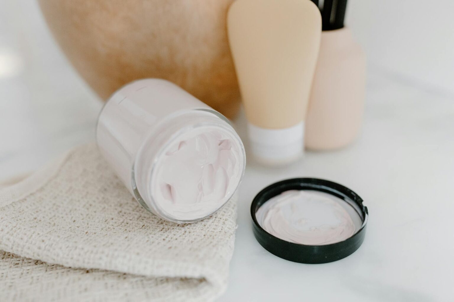 How Celebrity Makeup Artists Are Using Probiotic Skincare for Red Carpets Professional skincare products arranged on a clean white surface for beauty treatment preparation