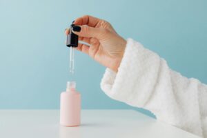How Peptide Serums Became the New Botox Alternative for Millennials Close-up of skincare serum bottle with dropper, representing peptide-based anti-aging products