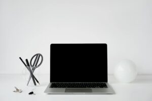 Person organizing digital files on laptop computer with clean workspace