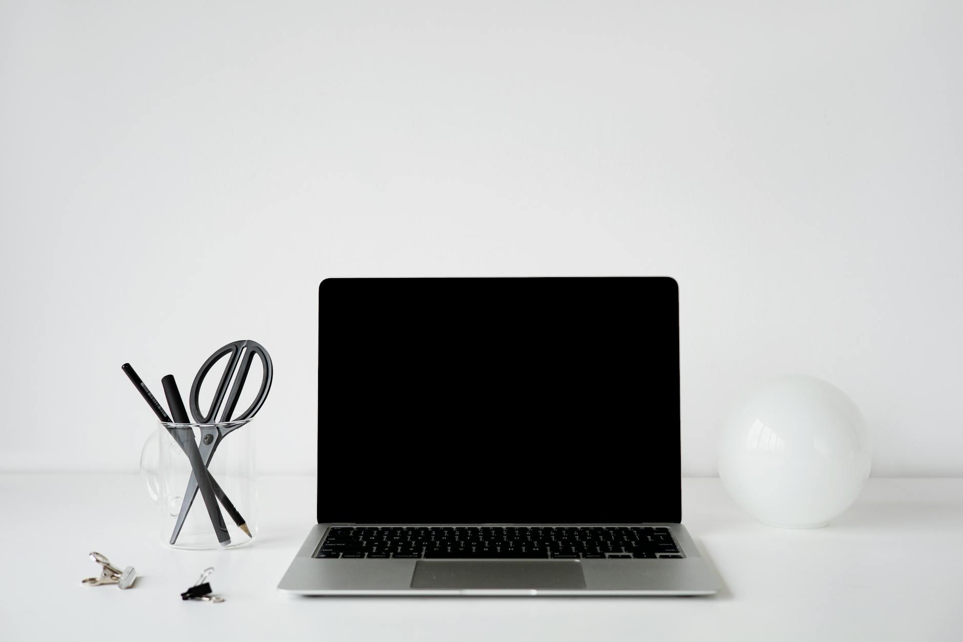 Person organizing digital files on laptop computer with clean workspace