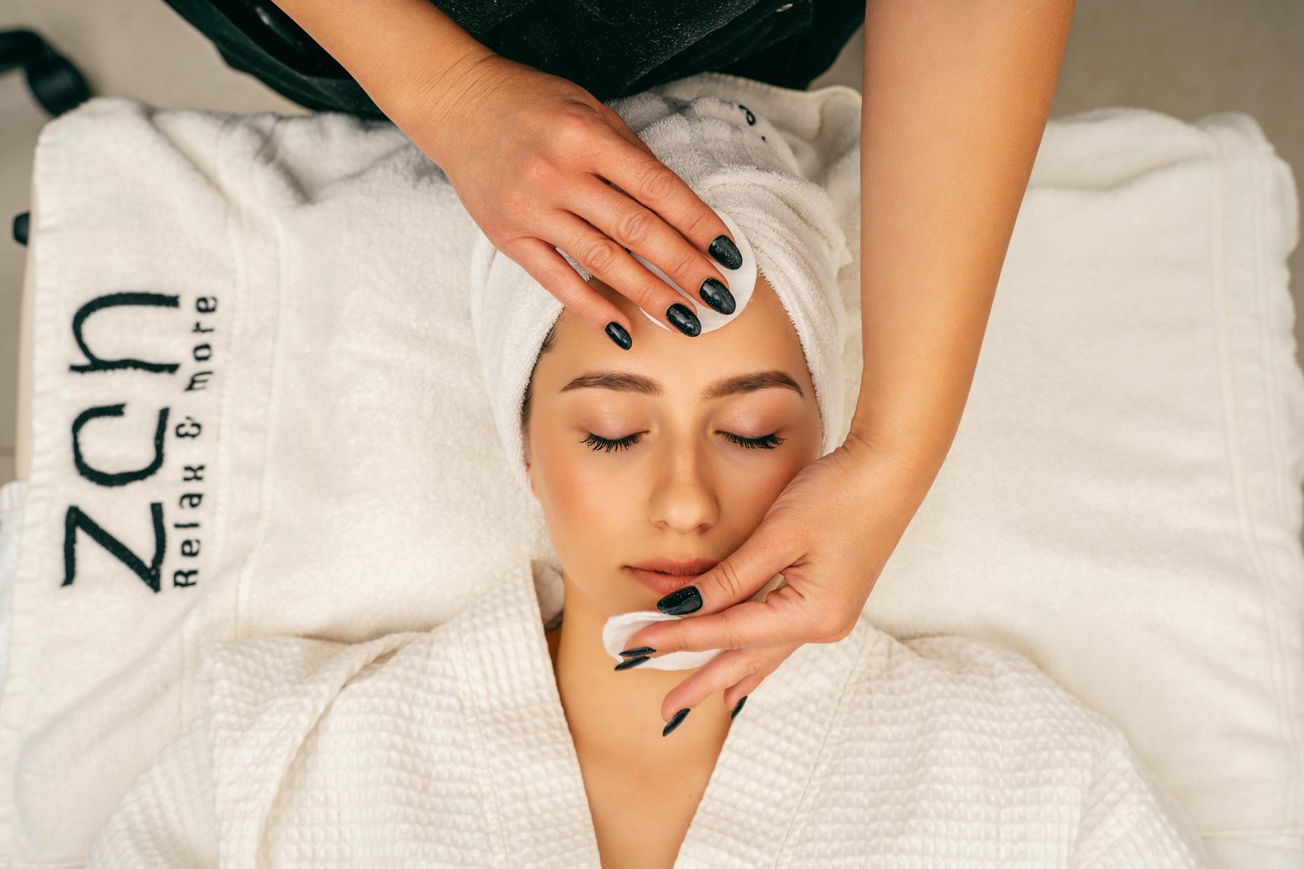 Person receiving professional scalp massage treatment at a spa