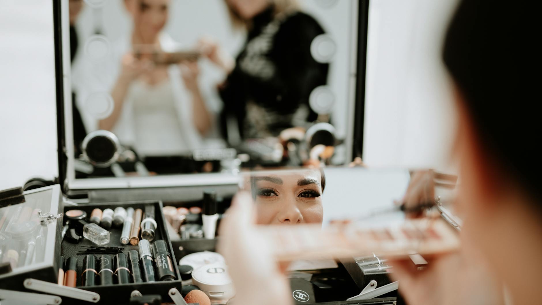 Bride having makeup applied during wedding preparation