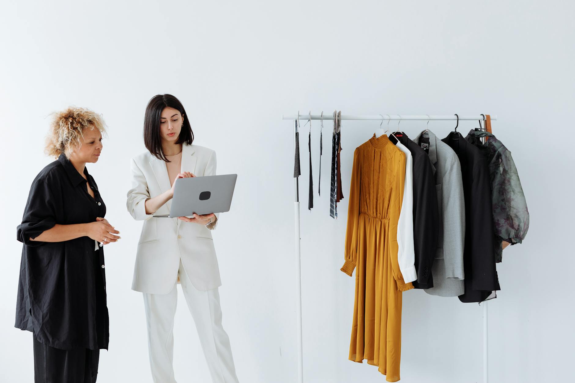 Professional woman selecting business attire from organized wardrobe
