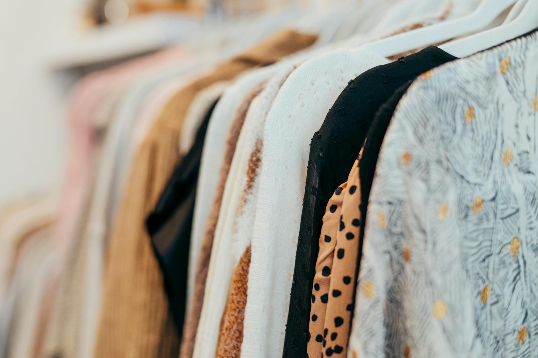 Vintage clothing hanging on rack in thrift store or consignment shop