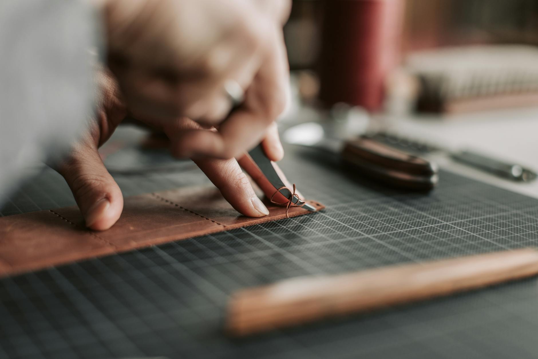 Leather working tools and materials arranged on a work surface
