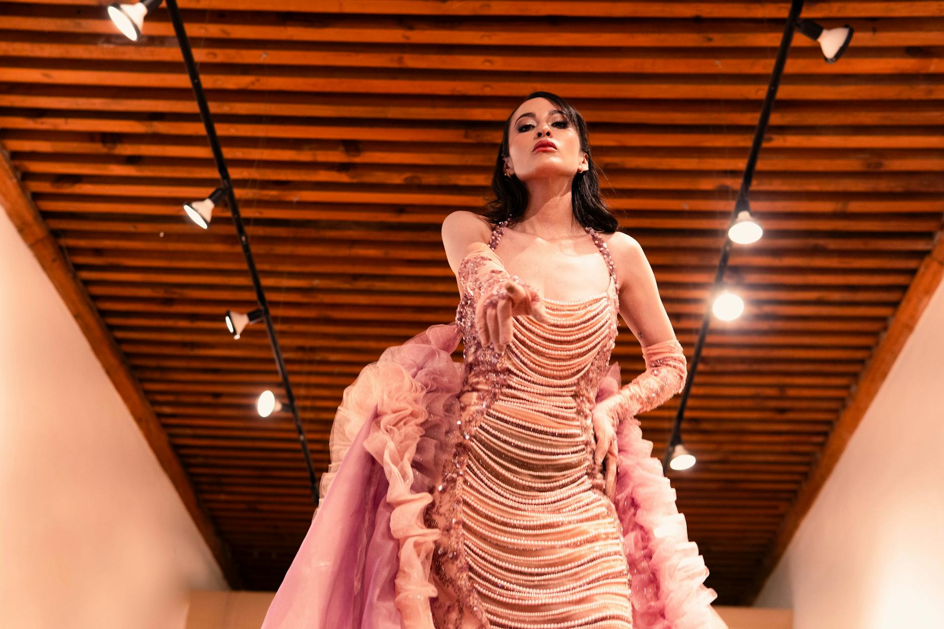 Models walking on fashion runway during indoor fashion show presentation