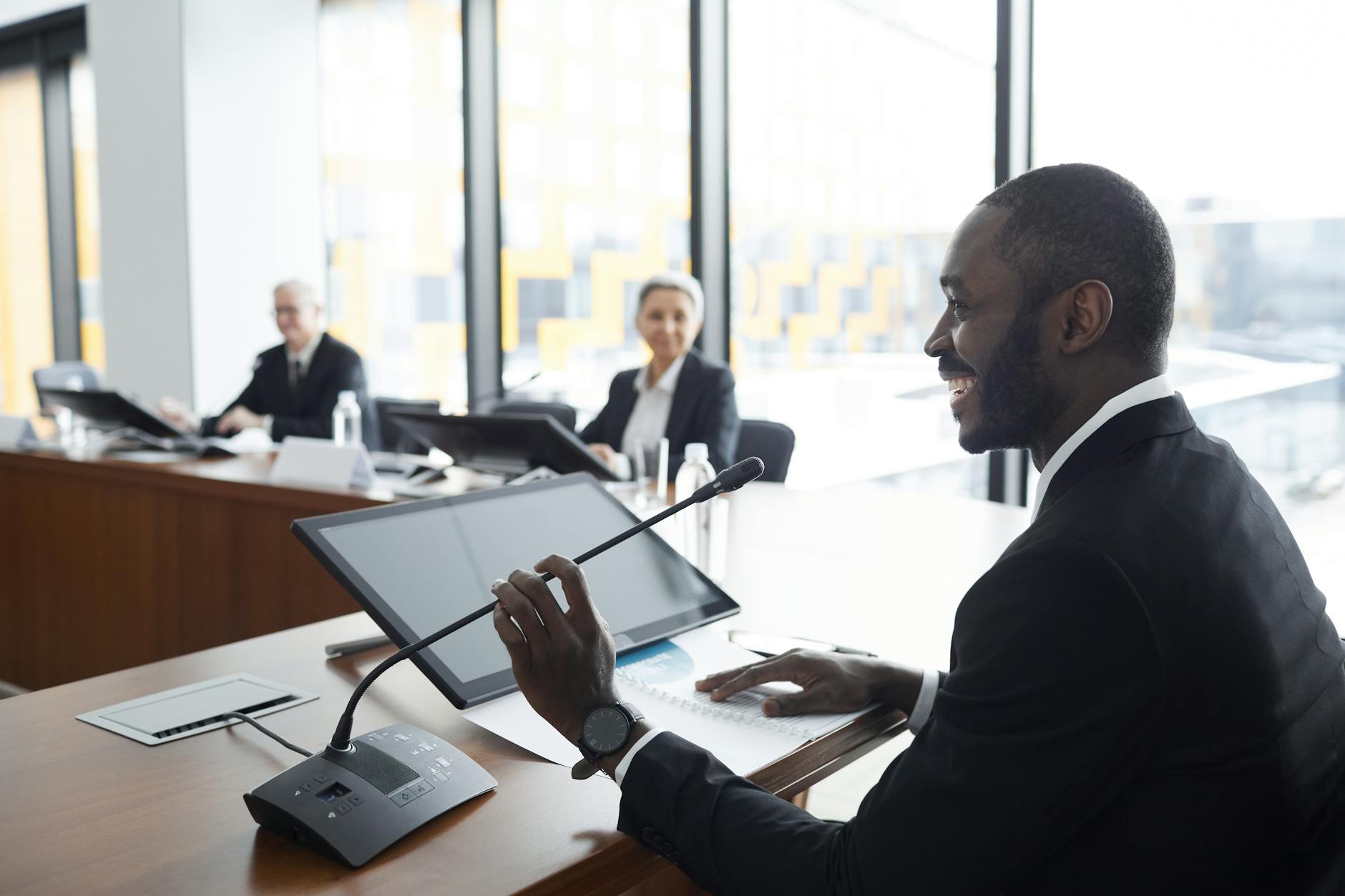 Business professionals in meeting room wearing formal attire