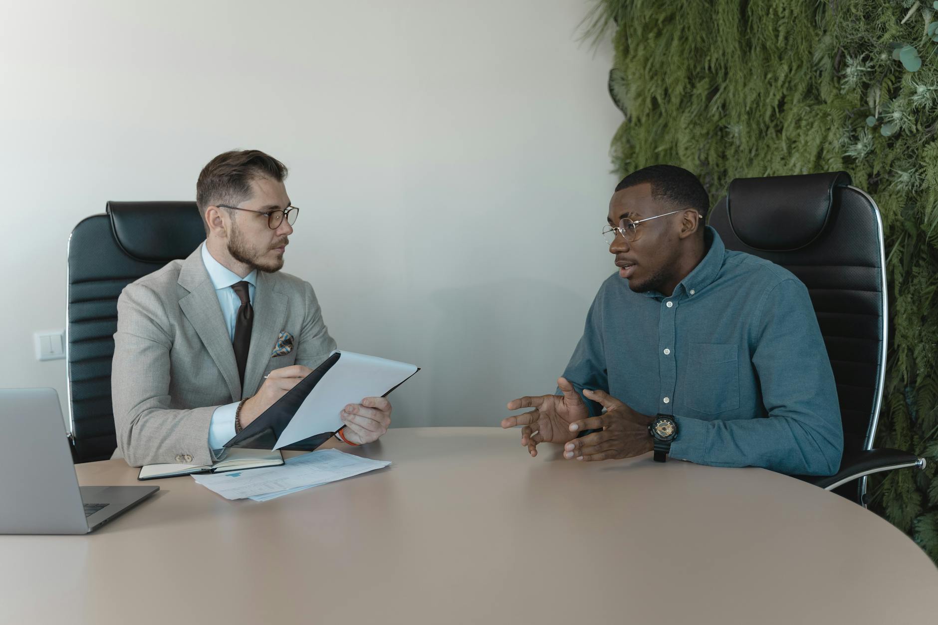 Professional woman in business attire sitting confidently during a job interview in a modern office setting