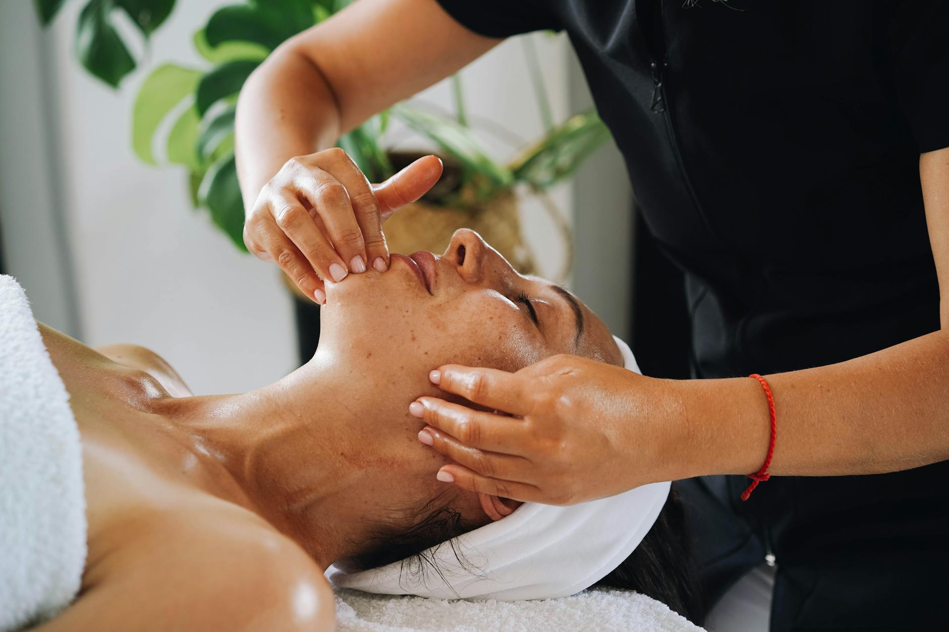 Person performing facial massage routine demonstrating skincare wellness practice