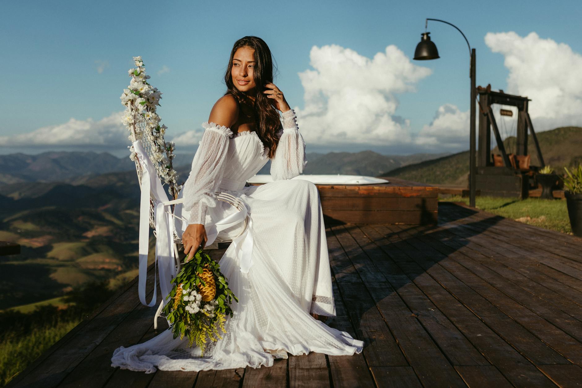 Smiling bride in vintage-style wedding dress posing outdoors for wedding photos