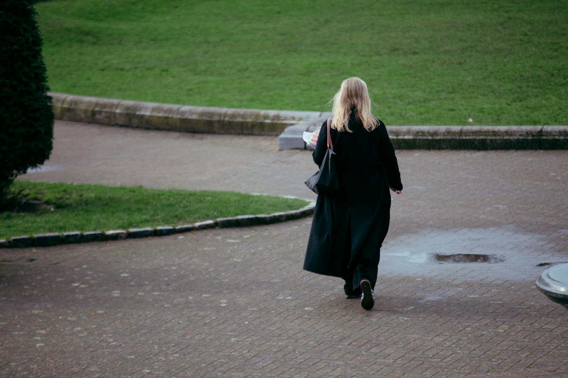 Professional woman walking confidently in business attire and heels