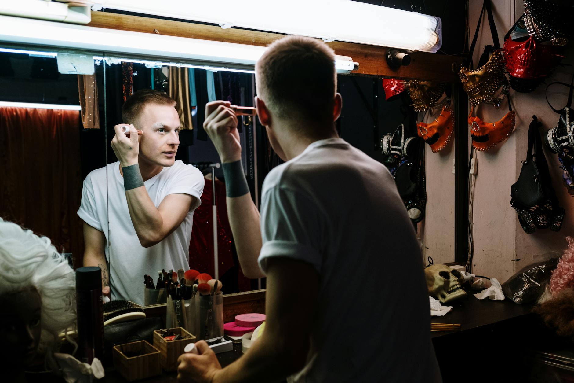 Backstage dressing room with illuminated vanity mirror and makeup station