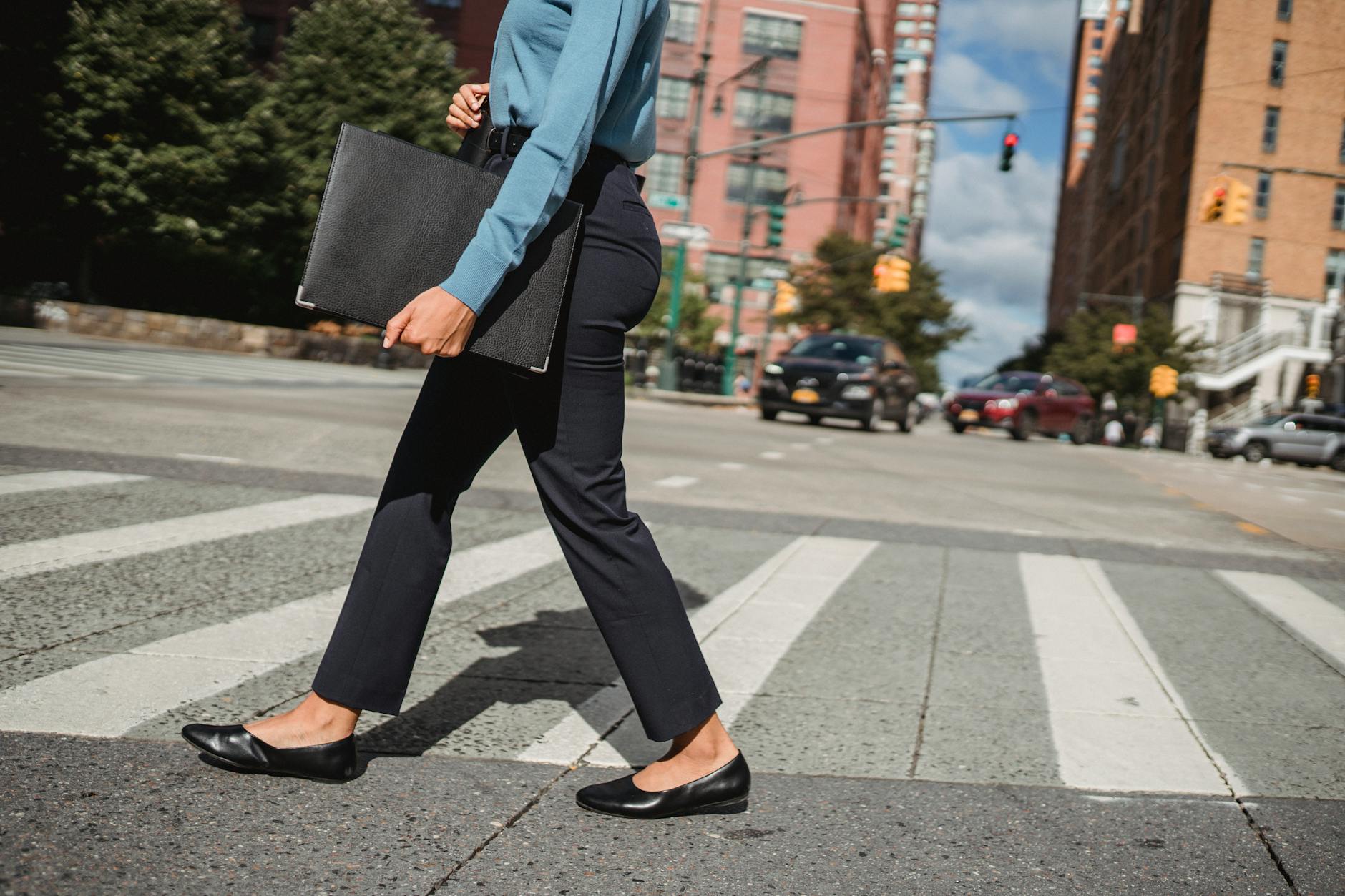Professional businesswoman walking confidently in corporate hallway wearing business attire