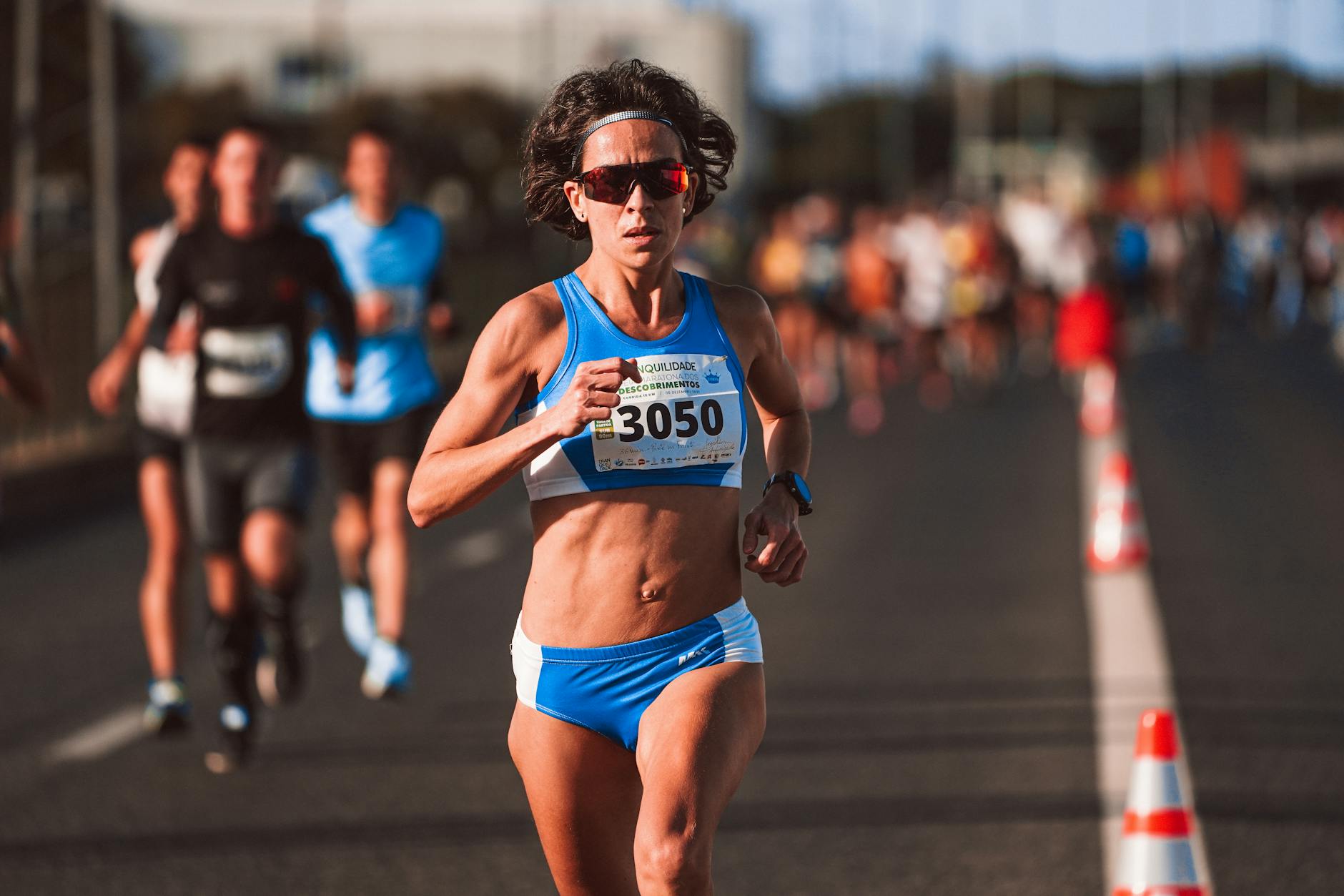 Group of marathon runners competing in long-distance race on city street