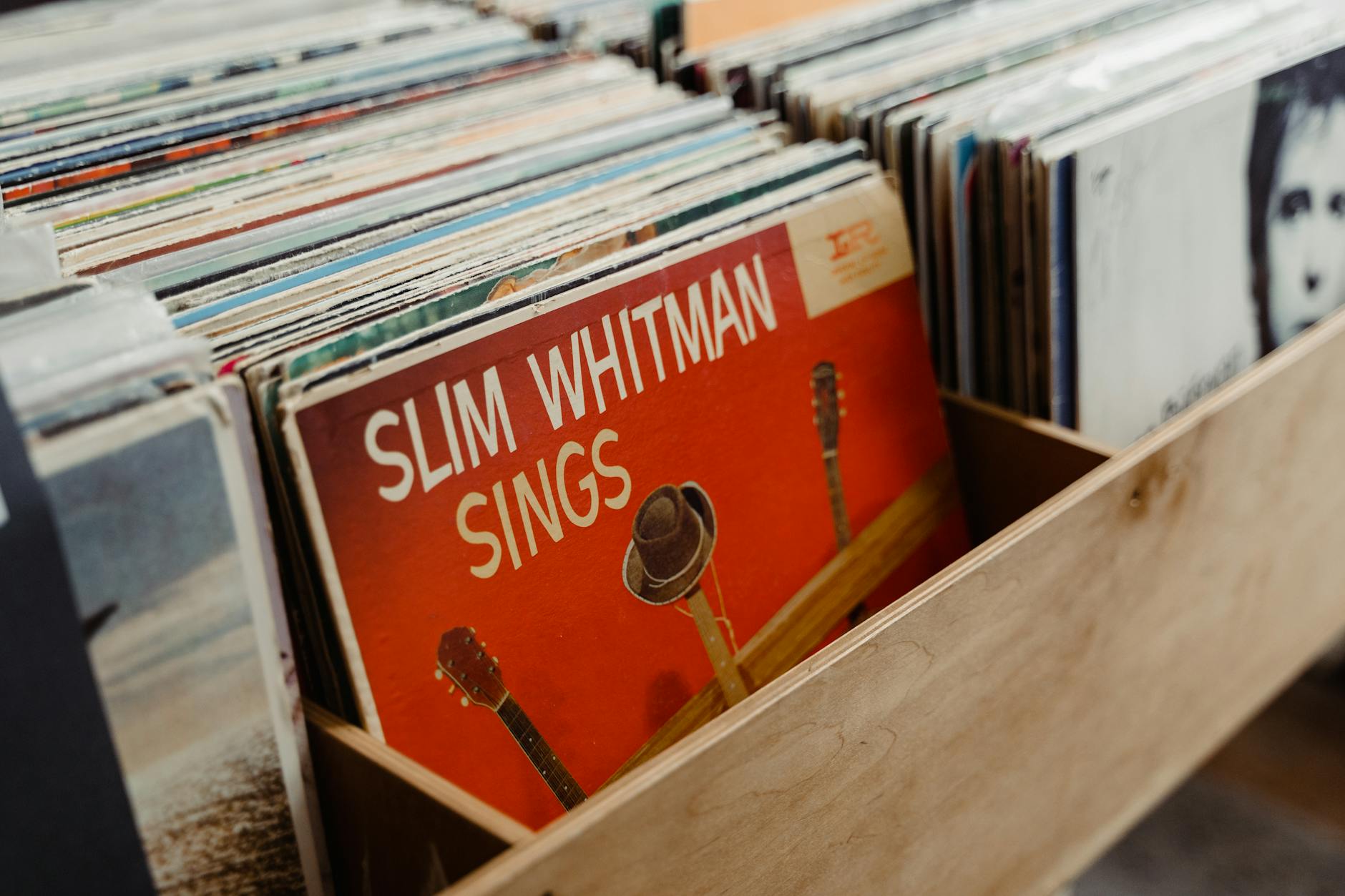 Collection of vintage vinyl records and music memorabilia arranged on wooden shelves