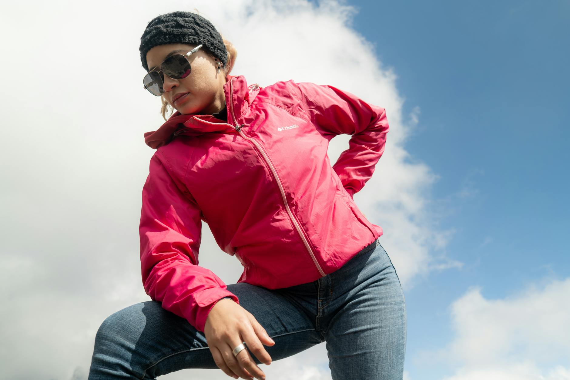 Fashion presentation in natural outdoor setting with models and audience in garden environment