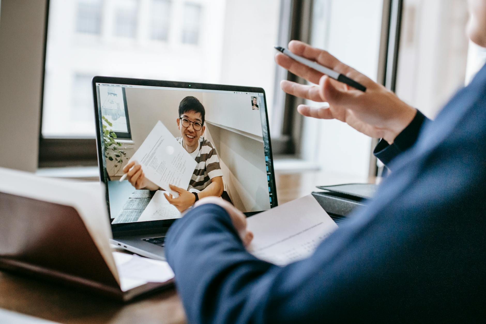 Person participating in professional video conference call from home office