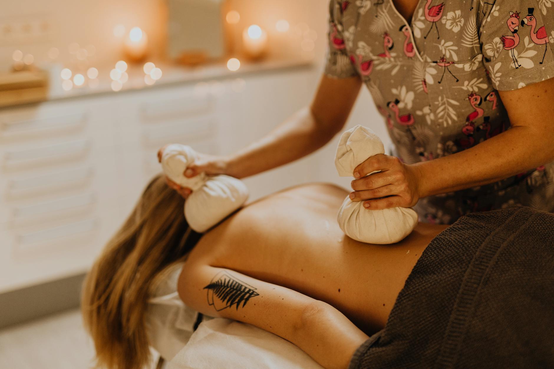 Beauty professionals learning massage techniques in training classroom environment